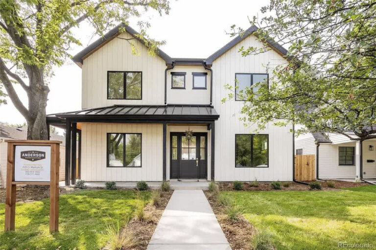 Front exterior of white two-story home at 2355 S. Madison St.