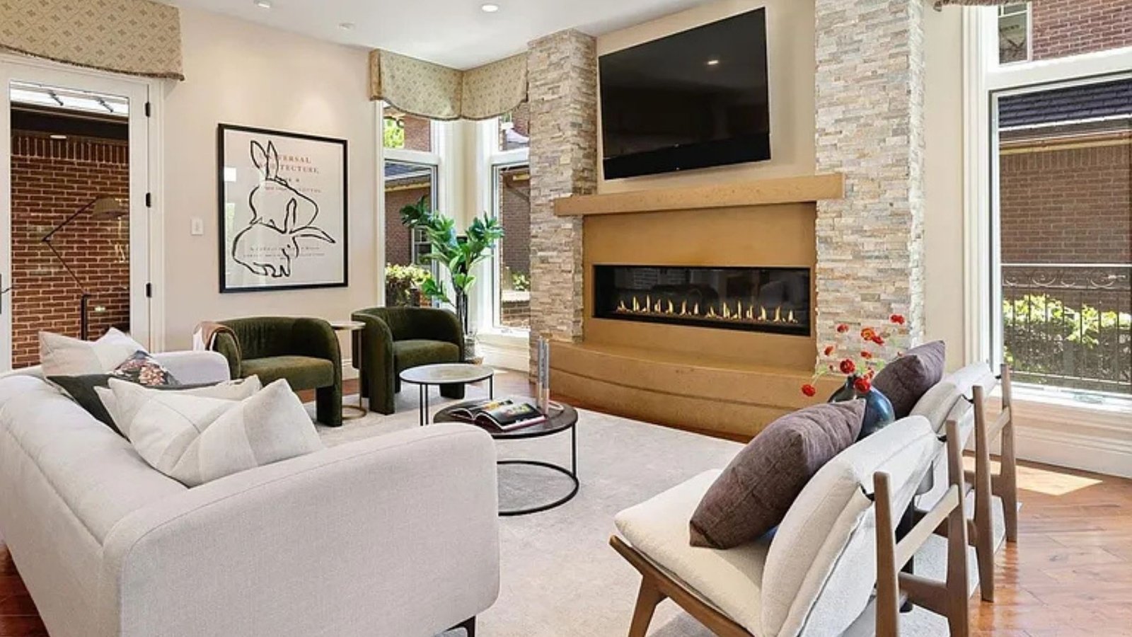 Stone fireplace green velvet chairs